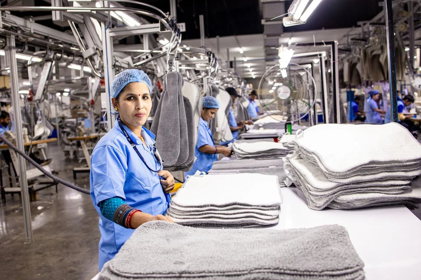 Workers and textile machinery inside an Indian factory